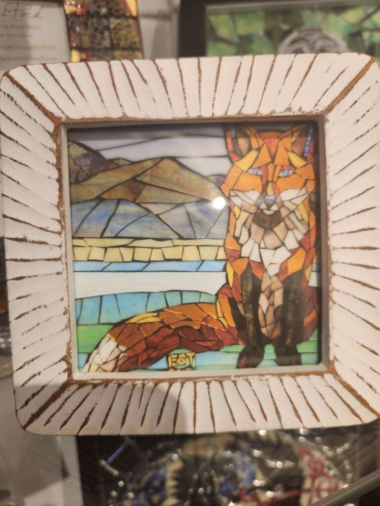 framed artwork of a fox with mountains behind it