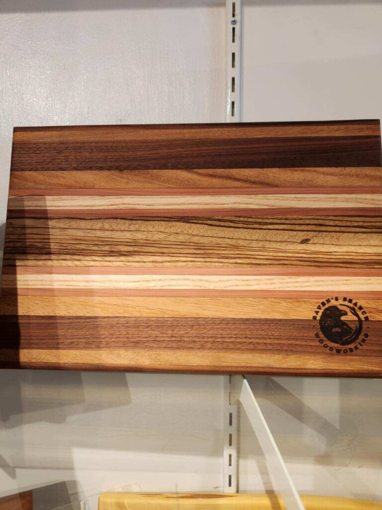 handmade wooden cutting board with logo burned into the bottom right corner